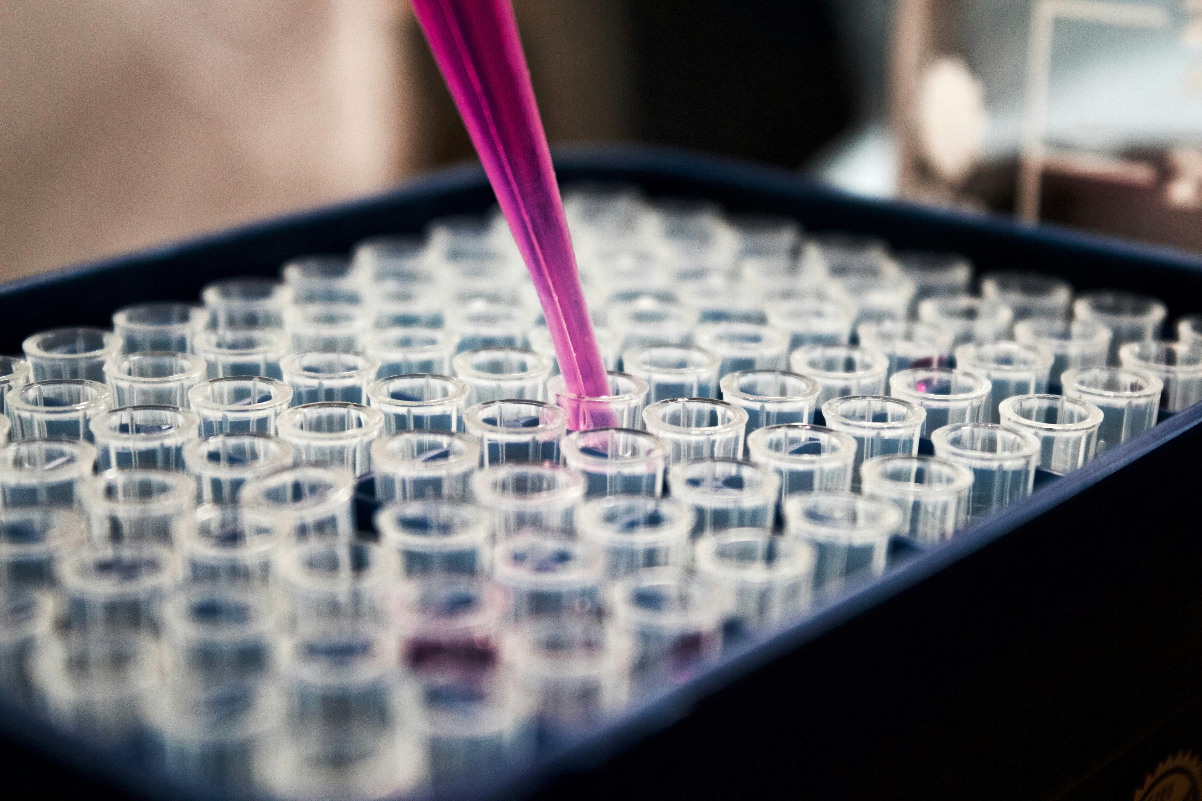 Quality control scientist formulating supplement compounds in a certified laboratory